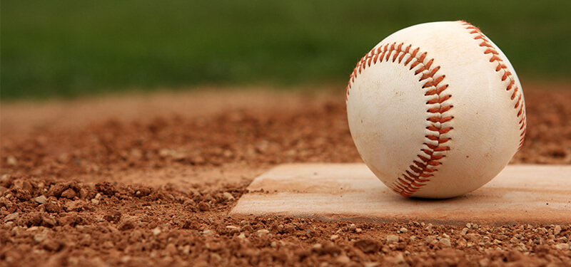 Baseball Sitting on a Mound Photo