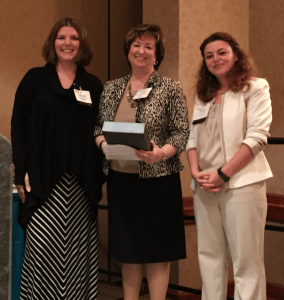 Vickie Martin, center, receives the “Experienced Leader” award from Melisa Galasso, right, and Yasmine El-Ramly, left, at the Professional Women’s Conference in Cary, NC on October 22, 2015. 