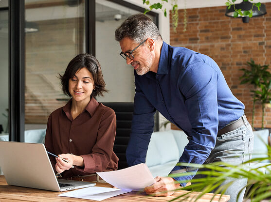 Man and woman looking at a laptop